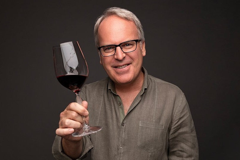 Photo of James Suckling with a glass of Pinot Noir. 